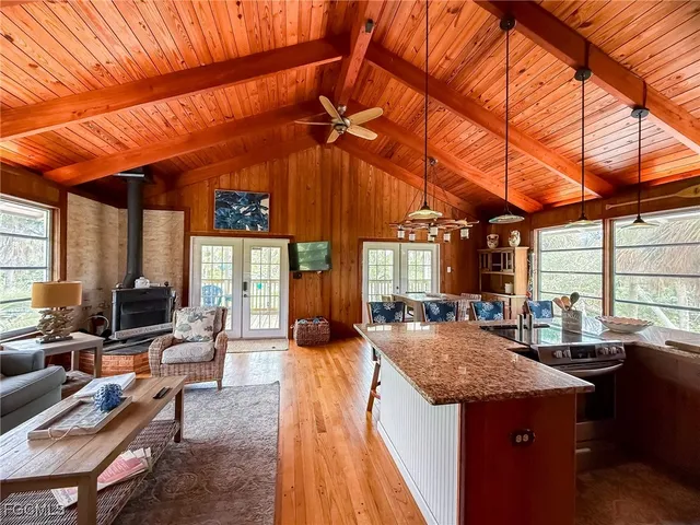 a dining hall with stainless steel appliances granite countertop a stove and cabinets