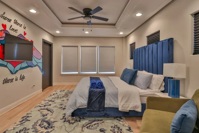 a bedroom with a large bed and a window