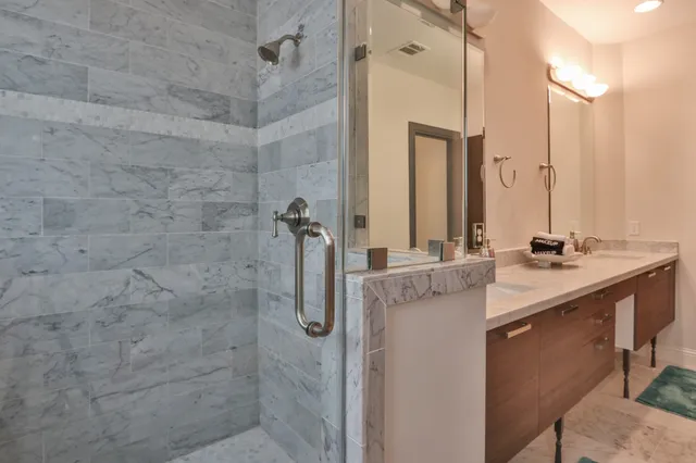 a bathroom with a sink a mirror and shower