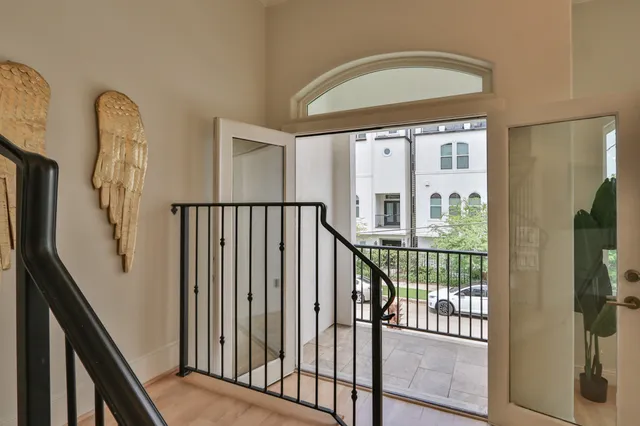 a view of staircase with wooden floor and fan