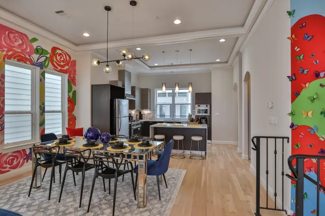 a view of a dining room with furniture and a chandelier