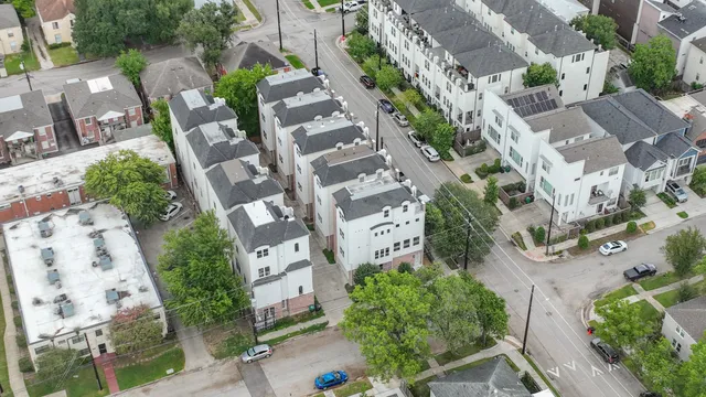 an aerial view of multiple houses with yard