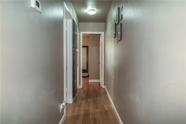a view of hallway with wooden floor