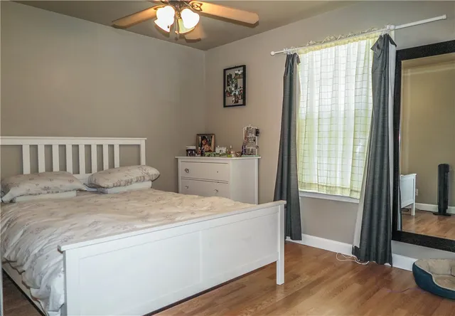 a bedroom with a bed and a flat tv screen on the dresser
