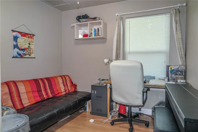 a living room with a couch and a dresser next to a window