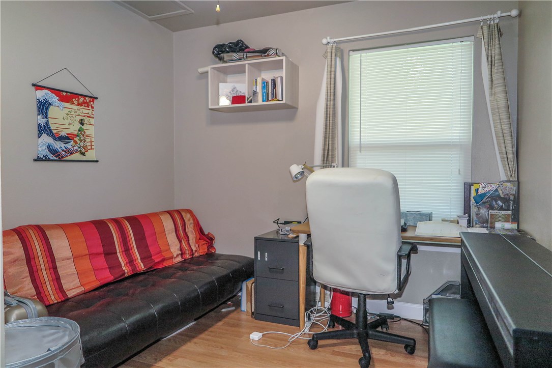 3905 Chase Circle, Unit B Austin, TX 78721 - Photo 16 of 18 a living room with a couch and a dresser next to a window