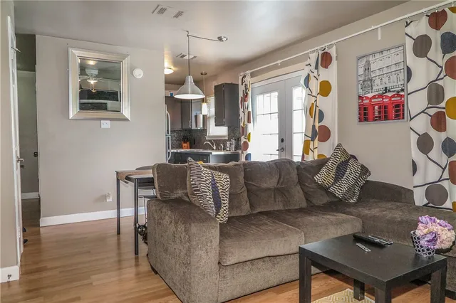 a living room with furniture and wooden floor