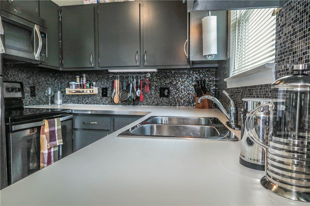 3905 Chase Circle, Unit B Austin, TX 78721 - Photo 10 of 18 a kitchen with granite countertop a sink a stove and cabinets
