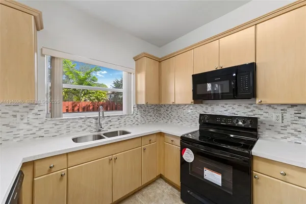 a view of a hallway with wooden floor and stairs