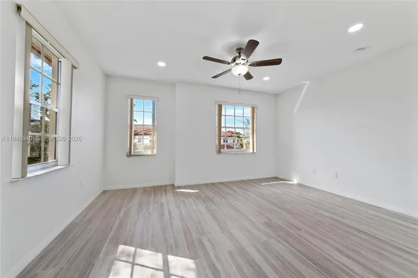 a bathroom with a tub a sink and mirror
