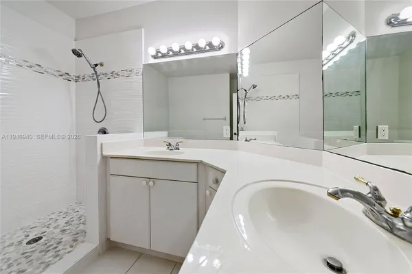 a bathroom with a tub sink a shower and vanity