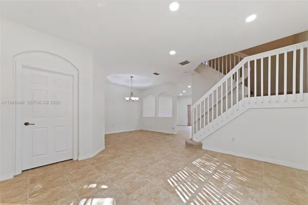 a view of an empty room with windows