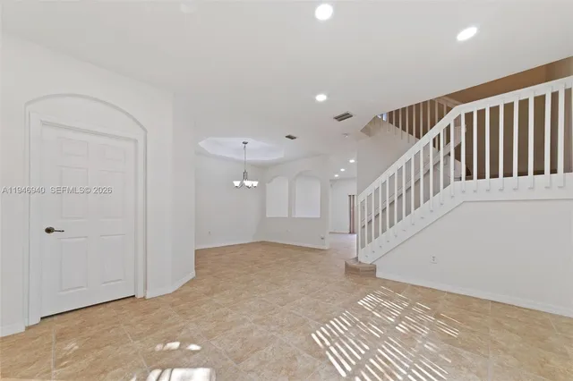 a view of an empty room with windows