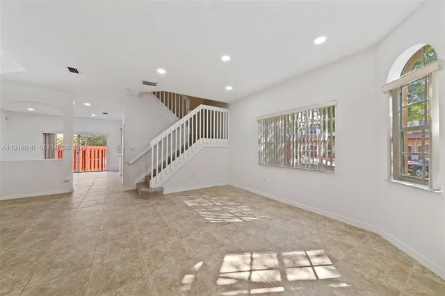 a view of an empty room with windows