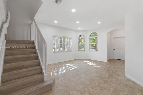 an empty room with windows and closet