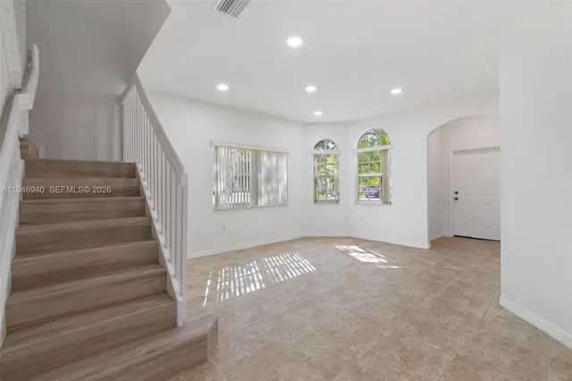 an empty room with windows and closet