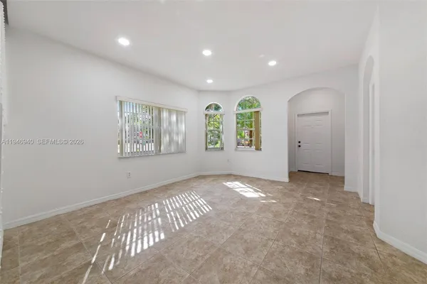 a view of an empty room with a chandelier