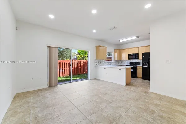 a kitchen with a stove a sink and a microwave