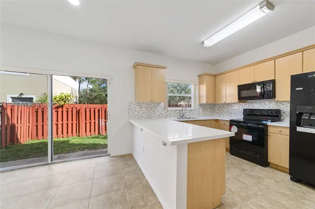 a kitchen with a sink stove and microwave