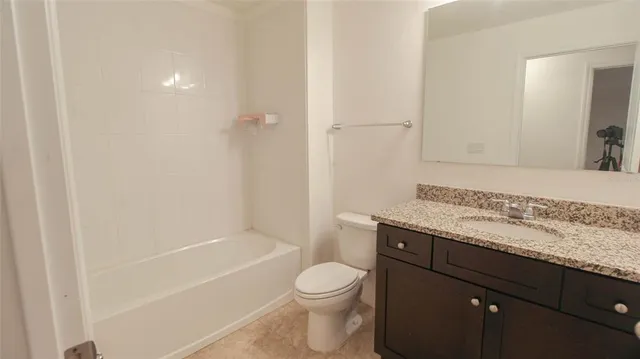 a view of kitchen with kitchen island granite countertop a stove top oven a sink and a refrigerator