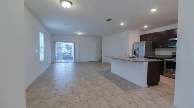 a kitchen with stainless steel appliances a refrigerator and a stove top oven