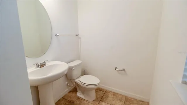 a white toilet sitting next to a bathroom sink