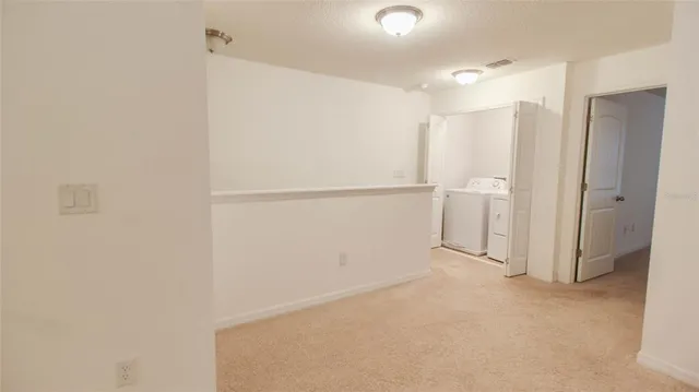 a view of an empty room and a window