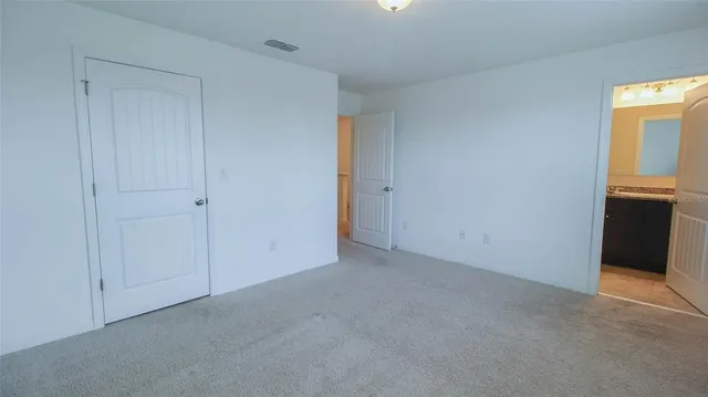 an empty room with windows and closet