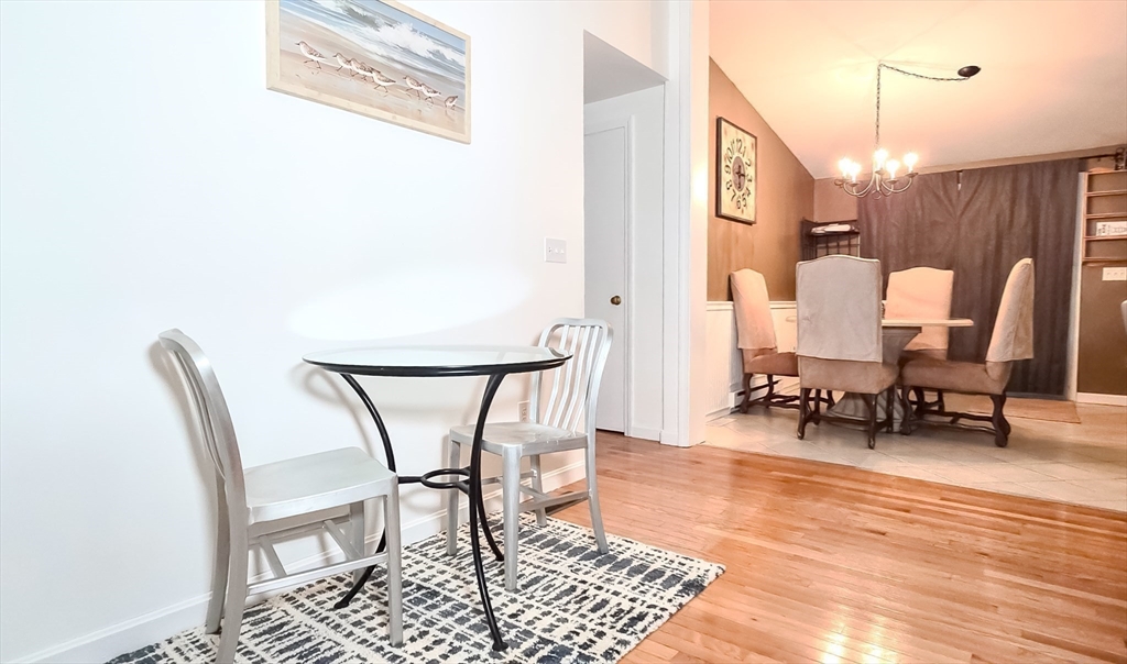 7 Roosevelt Street Wareham, MA 02571 - Photo 14 of 28 a living room with chairs and a table with wooden floor