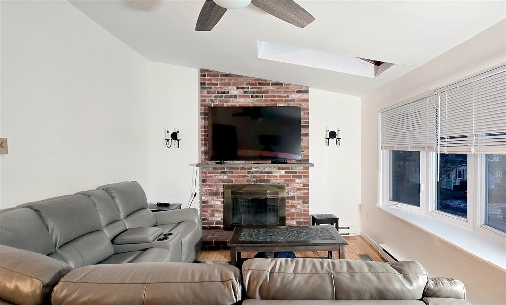 7 Roosevelt Street Wareham, MA 02571 - Photo 17 of 28 a living room with furniture and a fireplace