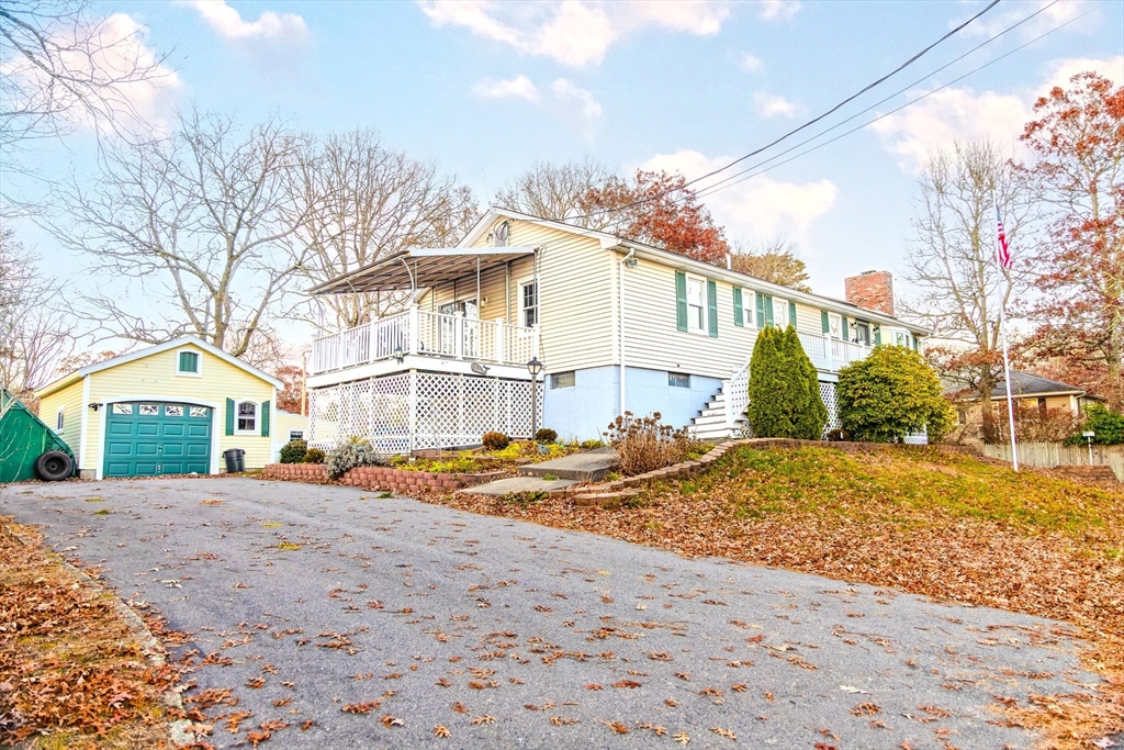 7 Roosevelt Street Wareham, MA 02571 - Photo 3 of 28 a view of a white house next to a yard with a large tree