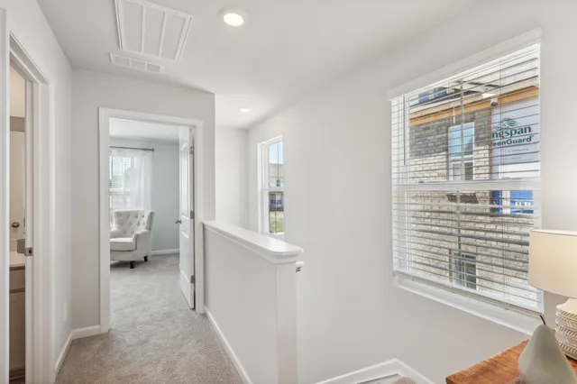 a view of hallway with livingroom and furniture