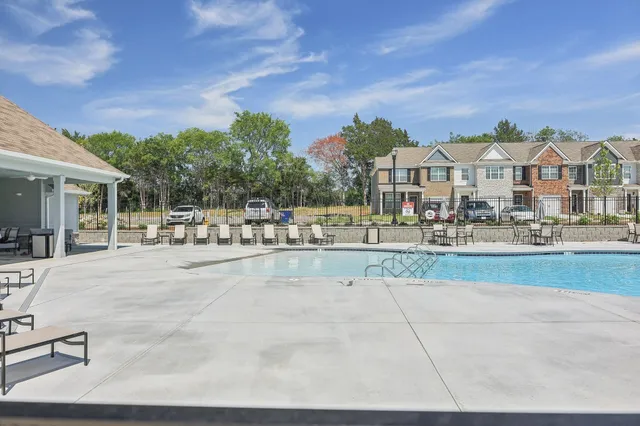 a view of house with yard and sitting area