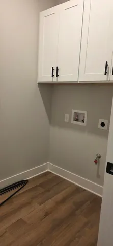a large white kitchen with stainless steel appliances granite countertop a stove and a sink