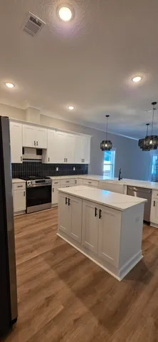 a kitchen with a stove and a refrigerator
