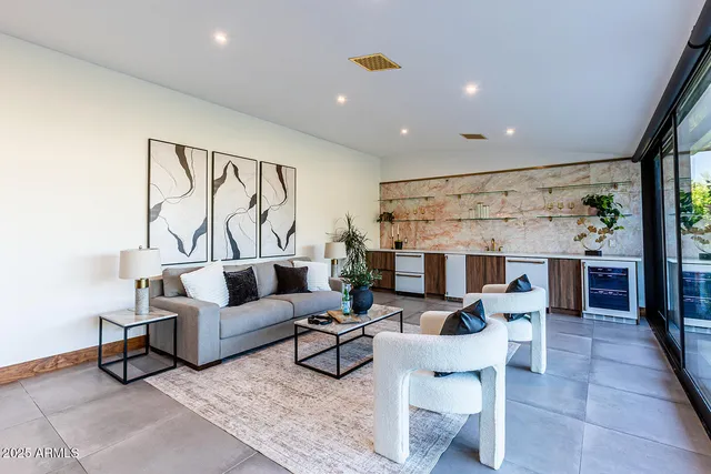 a kitchen with stainless steel appliances kitchen island granite countertop a table and chairs in it