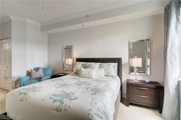 a bedroom with a bed and a lamp