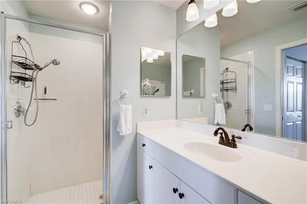 a bathroom with a sink vanity tub and a mirror