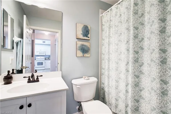 a bathroom with a sink toilet and mirror