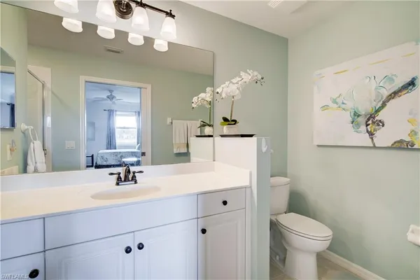 a bathroom with a sink a toilet and a mirror