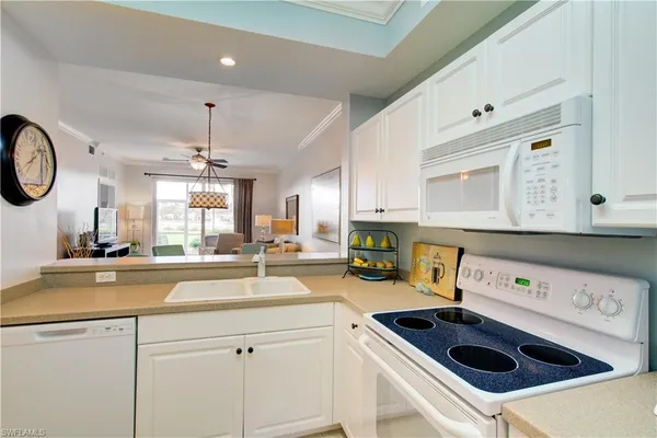 a kitchen with a sink a stove and cabinets