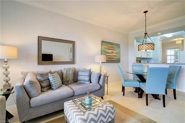 a living room with furniture wooden floor and a chandelier