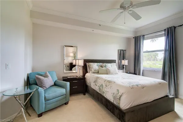 a bedroom with a bed couch and window