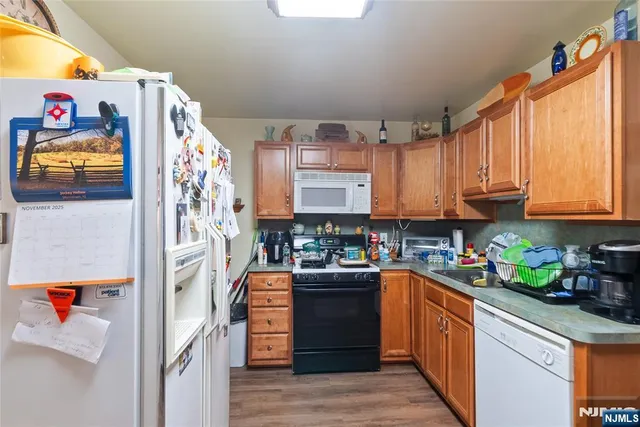 a kitchen with stainless steel appliances granite countertop a refrigerator sink and cabinets