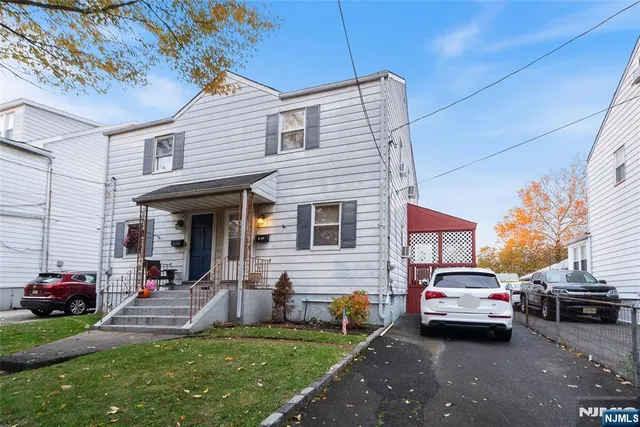 a couple of cars parked in front of a house