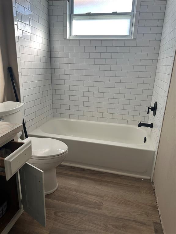 7027 Paul Revere Terrace New Port Richey, FL 34653 - Photo 11 of 20 a bathroom with a sink a toilet and bathtub