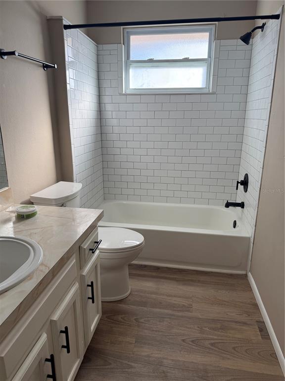 7027 Paul Revere Terrace New Port Richey, FL 34653 - Photo 12 of 20 a bathroom with a granite countertop sink toilet and shower