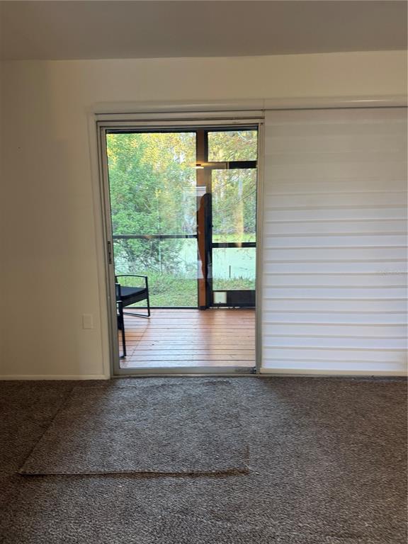 7027 Paul Revere Terrace New Port Richey, FL 34653 - Photo 14 of 20 a view of empty room with wooden floor and fan