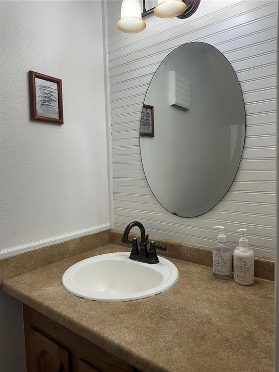 7027 Paul Revere Terrace New Port Richey, FL 34653 - Photo 15 of 20 a bathroom with a sink and a mirror