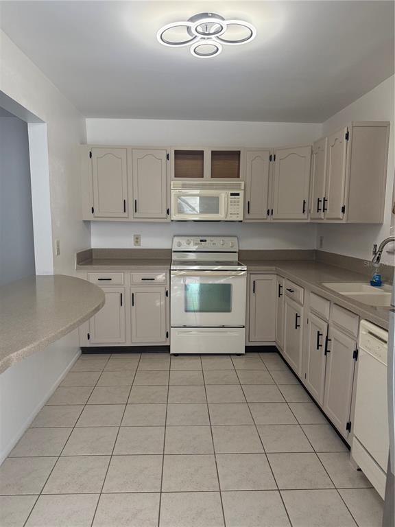 7027 Paul Revere Terrace New Port Richey, FL 34653 - Photo 2 of 20 a kitchen with stainless steel appliances granite countertop a stove sink and cabinets